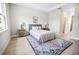 Bedroom featuring a comfortable bed, stylish rug, and natural light from the window at 308 Miami Ln, Kissimmee, FL 34759