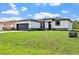 Modern single-Gathering home featuring a black garage door and stylish stone accents on the facade at 308 Miami Ln, Kissimmee, FL 34759