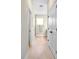 Bright hallway with white doors and light wood floors, leading to other rooms in the house at 308 Miami Ln, Kissimmee, FL 34759