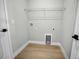 Neutral laundry room with wood look tile flooring and convenient washer and dryer hookups at 308 Miami Ln, Kissimmee, FL 34759
