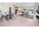 Open-concept living area with light wood floors, a dining space, and sliding glass doors to the outdoors at 308 Miami Ln, Kissimmee, FL 34759