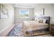 Inviting bedroom with a plush bed, a large window, and a stylish area rug creating a cozy atmosphere at 308 Miami Ln, Kissimmee, FL 34759