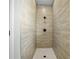 Modern walk-in shower with stylish tilework and sleek fixtures, creating a spa-like experience at 308 Miami Ln, Kissimmee, FL 34759