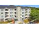 Low rise apartment complex with multiple balconies and a staircase tower offers modern living at 3176 Feltrim Pl # 202, Kissimmee, FL 34747