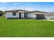Beautiful one-story home with modern architectural details and a lush green lawn at 370 Marion Oaks Crse, Ocala, FL 34473