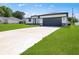 Well-maintained home with a long driveway leading to a spacious garage at 370 Marion Oaks Crse, Ocala, FL 34473