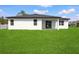 Spacious backyard featuring a covered patio and ample green space at 370 Marion Oaks Crse, Ocala, FL 34473