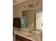 Bathroom featuring a large mirror, vanity with storage, and a well-lit space at 4710 Nathan Hale Blvd, St Cloud, FL 34769