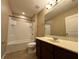 Bathroom featuring a vanity with granite counters, tub and shower combo at 4710 Nathan Hale Blvd, St Cloud, FL 34769