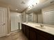 Spacious bathroom featuring a dual sink vanity, and glass enclosed shower at 4710 Nathan Hale Blvd, St Cloud, FL 34769