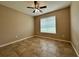 Clean bedroom with tile flooring, neutral walls, ceiling fan, and a window at 4710 Nathan Hale Blvd, St Cloud, FL 34769