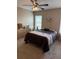 Bright bedroom with a ceiling fan, carpet, and a neutral color scheme with a projector installed on the wall at 4710 Nathan Hale Blvd, St Cloud, FL 34769