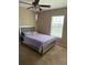 Cozy bedroom featuring a silver bed frame, ceiling fan and neutral-toned walls creating a peaceful retreat at 4710 Nathan Hale Blvd, St Cloud, FL 34769