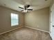 Inviting bedroom with large window, plush carpet and ceiling fan at 4710 Nathan Hale Blvd, St Cloud, FL 34769