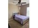 Cozy bedroom featuring a silver bed frame, ceiling fan and neutral-toned walls creating a peaceful retreat at 4710 Nathan Hale Blvd, St Cloud, FL 34769