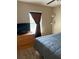 Bedroom with TV and dresser, a window with curtains, and neutral walls creating a cozy and inviting atmosphere at 4710 Nathan Hale Blvd, St Cloud, FL 34769