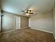 Bedroom with carpet floors, a ceiling fan, and a window for natural light at 4710 Nathan Hale Blvd, St Cloud, FL 34769