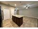 Kitchen island featuring granite countertop and cabinet storage at 4710 Nathan Hale Blvd, St Cloud, FL 34769