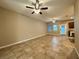 Bright open floor plan with tile flooring, ceiling fans, and access to the kitchen at 4710 Nathan Hale Blvd, St Cloud, FL 34769