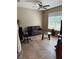 Cozy living room with neutral walls, comfortable seating, and natural light from a large window at 4710 Nathan Hale Blvd, St Cloud, FL 34769