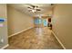 Spacious living room featuring tile flooring, neutral walls, and multiple ceiling fans at 4710 Nathan Hale Blvd, St Cloud, FL 34769