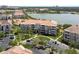 Serene aerial view of a lakeside condo complex showcasing well-manicured grounds and convenient parking at 5012 Shoreway Loop # 205, Orlando, FL 32819