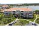 Aesthetic aerial view of a lakeside condo with lush lawns, convenient parking, and easy access at 5012 Shoreway Loop # 205, Orlando, FL 32819