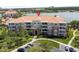 Aesthetic aerial view of a lakeside condo with lush lawns, convenient parking, and easy access at 5012 Shoreway Loop # 205, Orlando, FL 32819