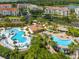 Overhead view of community pools surrounded by tropical landscaping, lounge chairs and cabanas, perfect for relaxing at 5012 Shoreway Loop # 205, Orlando, FL 32819