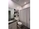 Bathroom with granite vanity top, and decorative shower curtain and picture at 9083 Coral Cape St, Kissimmee, FL 34747