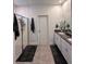 Bright bathroom featuring double sinks, granite countertops, and a glass-enclosed shower at 9083 Coral Cape St, Kissimmee, FL 34747