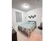 Cozy bedroom features soft natural light, neutral colors and modern geometric wall art at 9083 Coral Cape St, Kissimmee, FL 34747