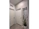 Hallway features elegant decorative mirror, neutral colors, and modern light fixture at 9083 Coral Cape St, Kissimmee, FL 34747