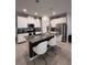 Modern kitchen featuring white cabinets, granite countertops, a center island, and stainless steel appliances at 9083 Coral Cape St, Kissimmee, FL 34747