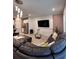 Inviting living room with modern lighting, accent wall, and comfortable seating with access to the kitchen at 9083 Coral Cape St, Kissimmee, FL 34747
