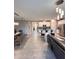 Spacious living area with a dining table, kitchen island, stainless steel appliances, and a comfortable sofa at 9083 Coral Cape St, Kissimmee, FL 34747