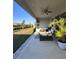 Outdoor patio area perfect for entertaining, with a ceiling fan and beautiful landscaping at 9083 Coral Cape St, Kissimmee, FL 34747