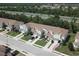 Aerial view of townhomes with manicured lawns, mature trees, and convenient access to the nearby highway at , Kissimmee, FL 34744