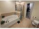 Bathroom featuring tub with shower, tiled floors, and walk-in closet at , Kissimmee, FL 34744