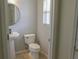 Bright half bath with pedestal sink, toilet, and tiled floors at , Kissimmee, FL 34744