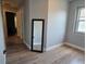 Neutral bedroom featuring wood-look floors and a standing mirror at , Kissimmee, FL 34744