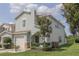 Charming two-story home featuring an attached garage, landscaped yard, and decorative stone accents at , Kissimmee, FL 34744