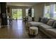 Bright living room featuring a modern sofa, open layout, tile floors, and natural light from a sliding door at , Kissimmee, FL 34744