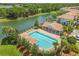 Community pool featuring a cabana, lounge chairs, and lush landscaping near the waterfront at , Kissimmee, FL 34744