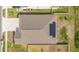Aerial view of a house with a brown roof and solar panels, showing its location in a neighborhood at 109 Pineywoods St, St Cloud, FL 34772