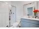 Clean, well-lit bathroom featuring a glass-enclosed shower, and modern vanity with a stylish mirror at 109 Pineywoods St, St Cloud, FL 34772