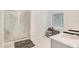 Bright bathroom with a glass shower, a single sink vanity and neutral decor at 109 Pineywoods St, St Cloud, FL 34772