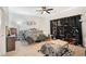 Bedroom with carpet flooring, ceiling fan, and decoratively accessorized with zebra and faux fur at 109 Pineywoods St, St Cloud, FL 34772
