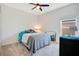 Bedroom with carpet flooring, fan, window, and bed with grey and teal bedding at 109 Pineywoods St, St Cloud, FL 34772