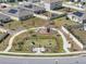 Overhead view of a fully fenced dog park with playful agility equipment and comfortable bench seating for pet owners at 109 Pineywoods St, St Cloud, FL 34772